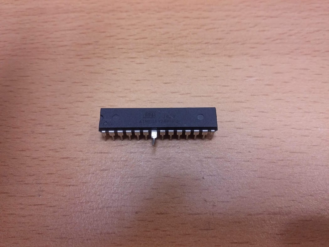 The ATmega328P with its VDD pin bent out.